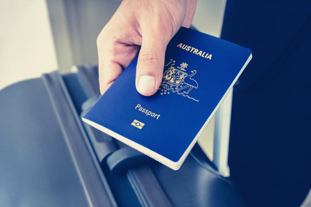 Hands giving passport (of Australia)